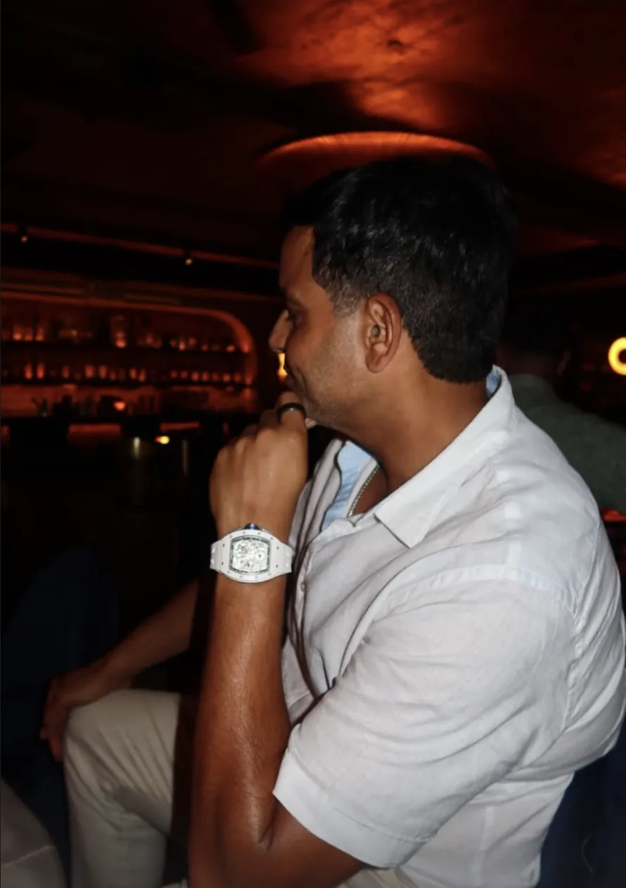 Kamran Farid seated, listening, with his hand at his chin