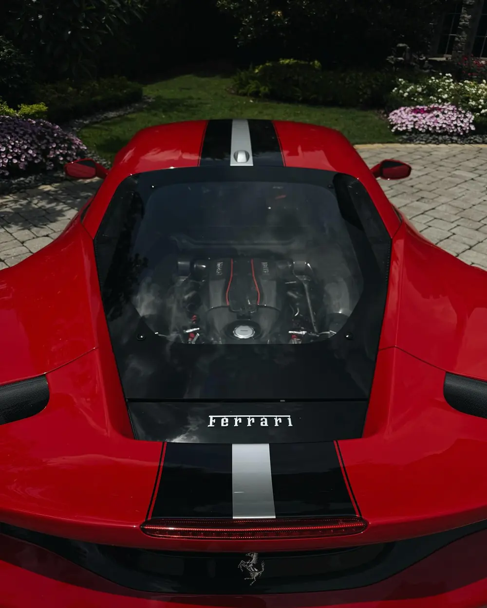Top-down view of a red Ferrari's engine cover