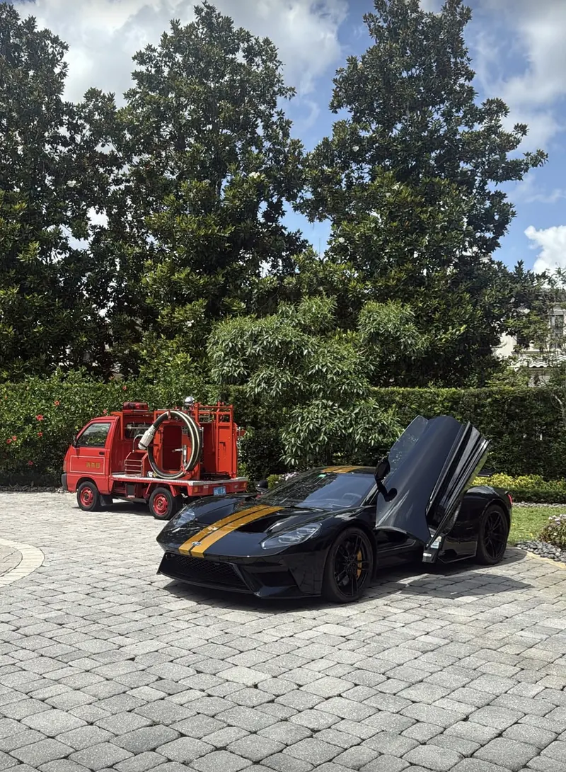 A black Ford GT with its doors up