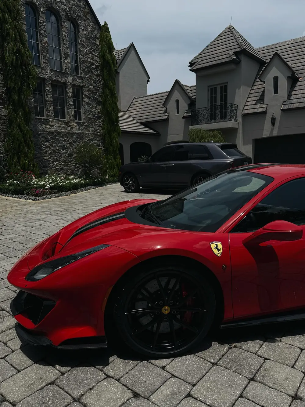 A red Ferrari in the stone driveway of Kamran's home